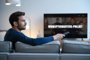 Man holding remote, watching IPTV interface with www.iptvsmarters-pro.net on screen